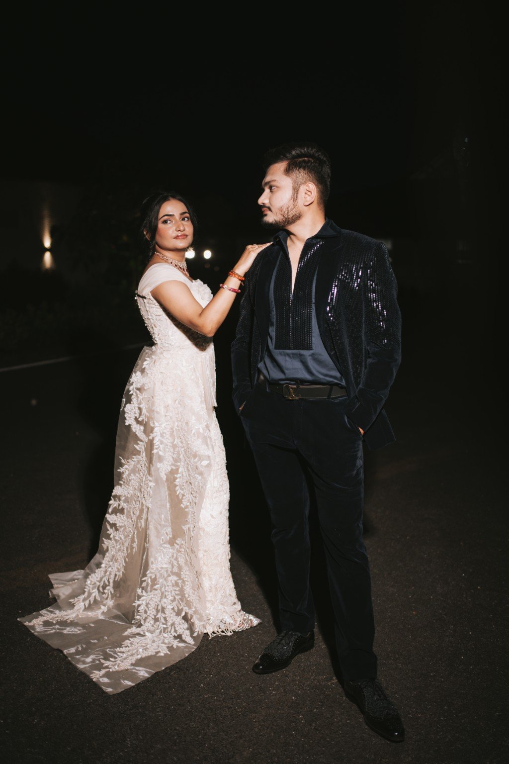 Om and Hima posing together under the night sky